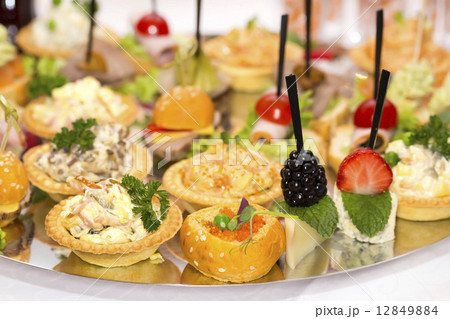 Canapes of cheese vegetables meat and seafood on white background Canapes of cheese vegetables meat and seafood on white background 12849884