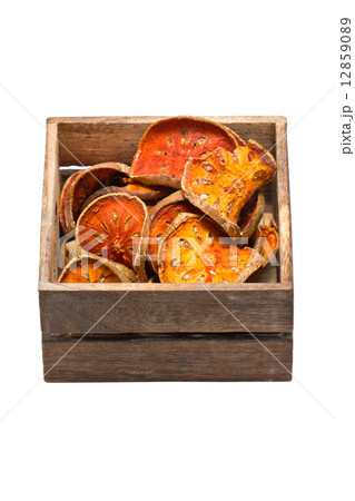 Slices of dried bael fruit with wooden box. 12859089