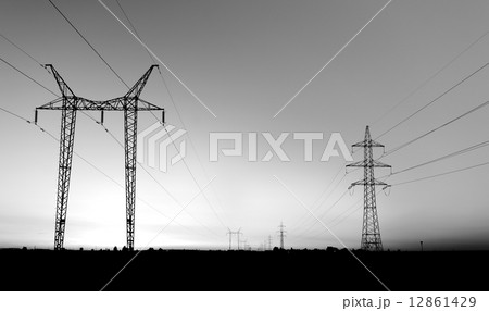 Large transmission towers at sunset Large transmission towers at sunset 12861429