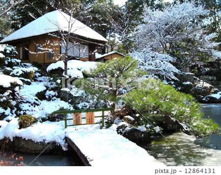 雪の庭園と茶室の写真素材