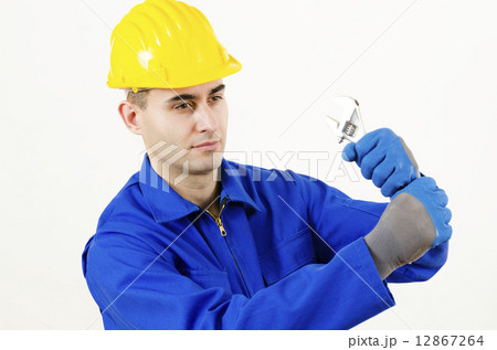 Man holding Adjustable Wrench 12867264