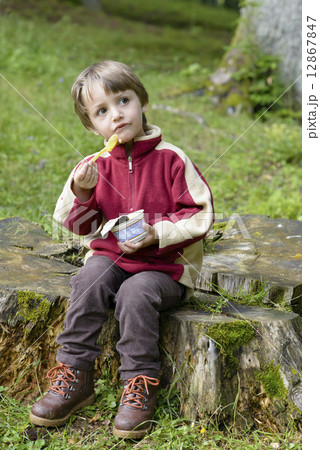 Boy Eating in forest Boy Eating in forest 12867847