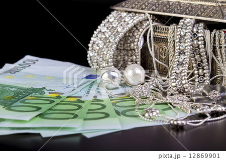 Silver jewelry and Euro on black Silver jewelry and Euro on black 12869901