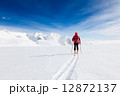 Mountaineer walking on a glacier during a high-altitude winter e Mountaineer walking on a glacier during a high-altitude winter e 12872137