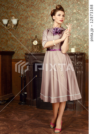 Pin Up beautiful young woman in vintage interior by the fireplace 12873168