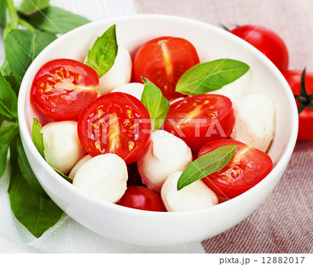 Caprese salad with mozzarella, tomato, basil on white plate. Vin Caprese salad with mozzarella, tomato, basil on white plate. Vin 12882017