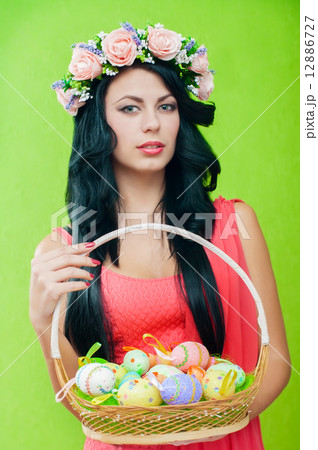 The beautiful girl with a basket of Easter eggs 12886727