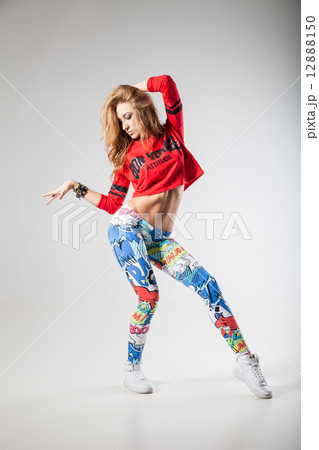 Modern dancer poses in front of studio background 12888150