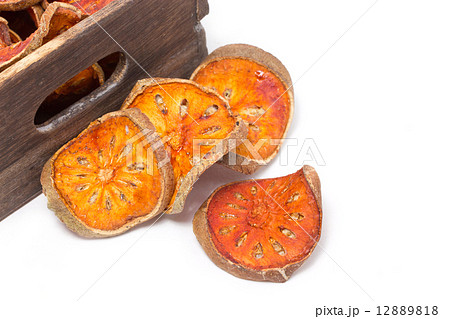 Slices of dried bael fruit with wooden box. 12889818