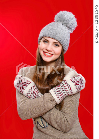 Beautiful girl in a knitted hat and gloves 12891545