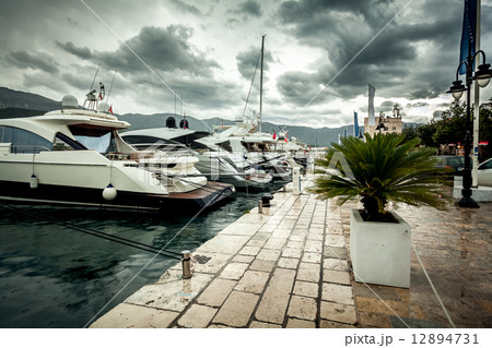view of moored luxurious yachts at cloudy and rainy day view of moored luxurious yachts at cloudy and rainy day 12894731