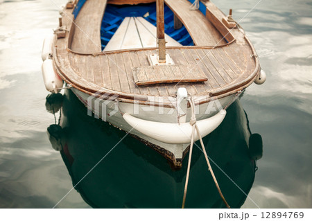 photo of moored old white wooden boat photo of moored old white wooden boat 12894769
