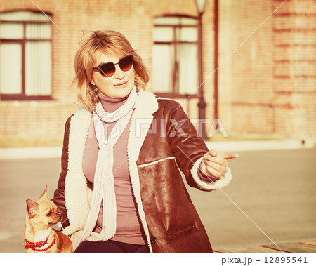 Cute Woman and Her Chihuahua Dog on Nature Background. Cute Woman and Her Chihuahua Dog on Nature Background. 12895541