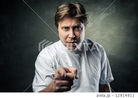 Portrait of angry young man pointing at you Portrait of angry young man pointing at you 12914911