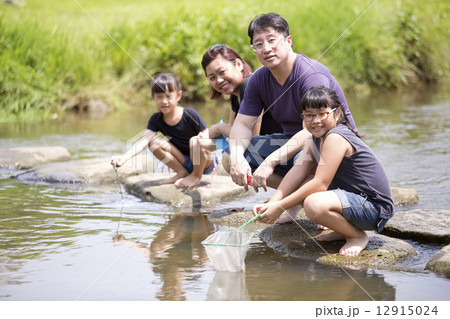 Young Asian family having fun by the river Young Asian family having fun by the river 12915024