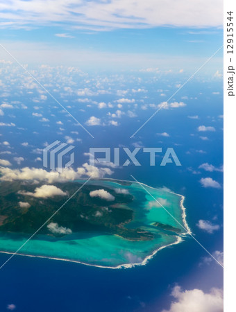 Polynesia. The atoll ring at ocean is visible through clouds. Aerial view Polynesia. The atoll ring at ocean is visible through clouds. Aerial view 12915544
