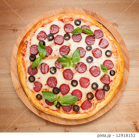 Fresh flavorful pepperoni pizza on wood 12918152