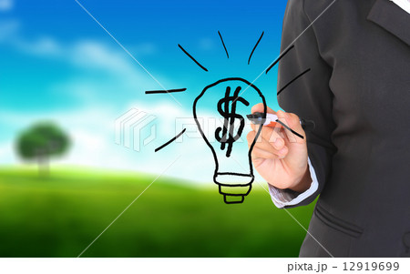 Businessman hand drawing and idea for making money on a natural 12919699