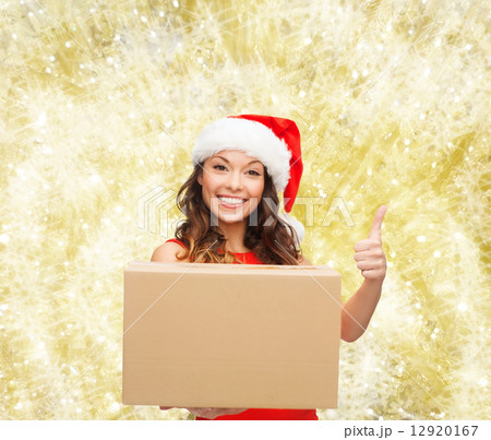 smiling woman in santa helper hat with parcel box 12920167