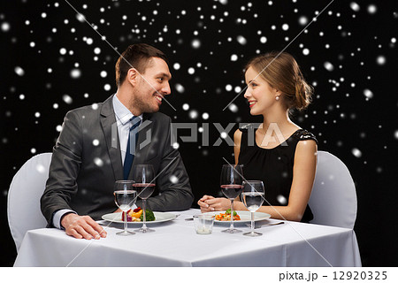 smiling couple eating main course at restaurant smiling couple eating main course at restaurant 12920325