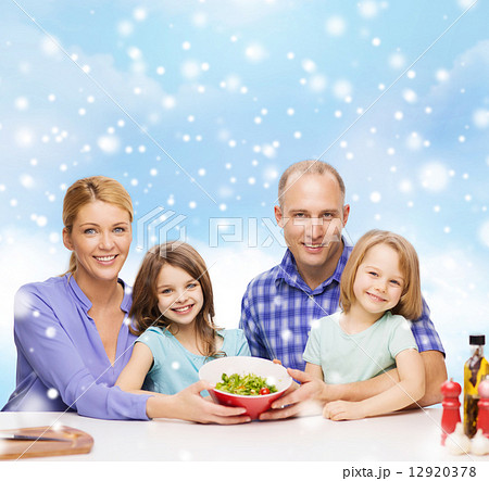 happy family with two kids showing salad in bowl happy family with two kids showing salad in bowl 12920378