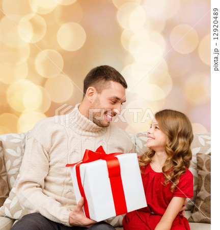 smiling father and daughter with gift box 12920489