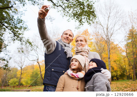 happy family with camera in autumn park happy family with camera in autumn park 12920666