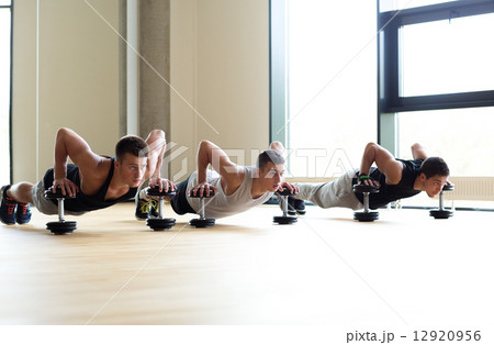 group of men with dumbbells in gym group of men with dumbbells in gym 12920956