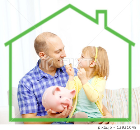 happy father and daughter with big piggy bank 12921048