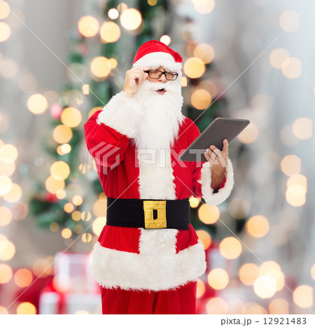man in costume of santa claus with tablet pc man in costume of santa claus with tablet pc 12921483