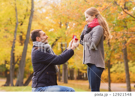 smiling couple with engagement ring in gift box smiling couple with engagement ring in gift box 12921548