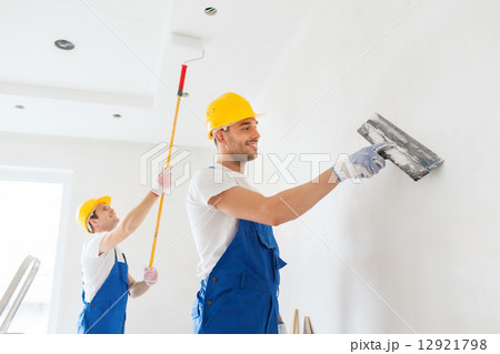 group of builders with tools indoors 12921798