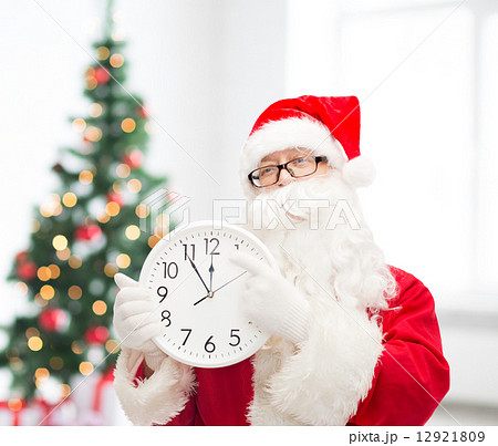man in costume of santa claus with clock 12921809