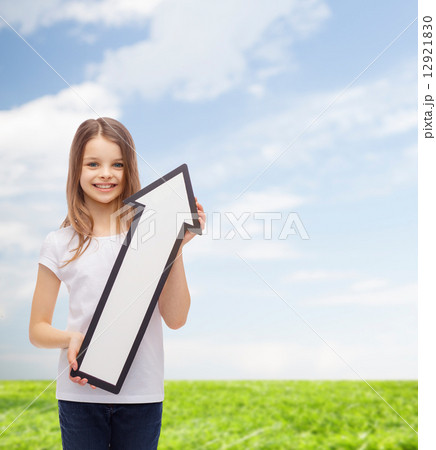 smiling little girl with blank arrow pointing up 12921830