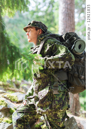 young soldier with backpack in forest young soldier with backpack in forest 12921835