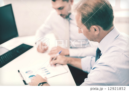 businessmen with notebook on meeting businessmen with notebook on meeting 12921852