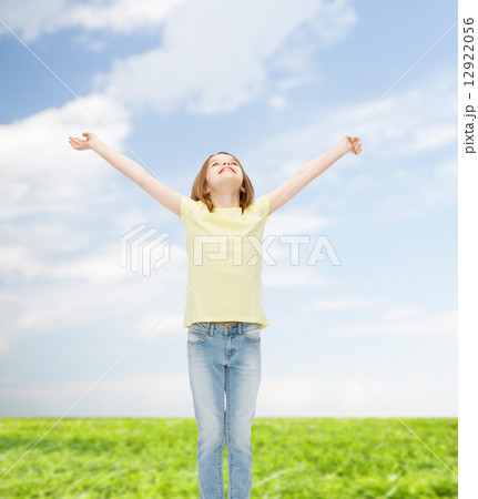 smiling teenage girl with raised hands 12922056