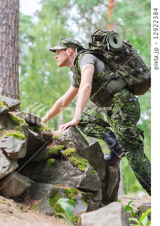 young soldier with backpack in forest young soldier with backpack in forest 12922384