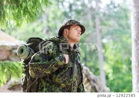young soldier with backpack in forest 12922585