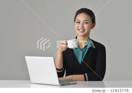 Asian Office Lady having a coffee break Asian Office Lady having a coffee break 12923776