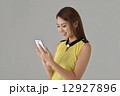 Asian lady texting with mobile phone Asian lady texting with mobile phone 12927896