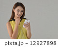 Asian lady texting with mobile phone Asian lady texting with mobile phone 12927898