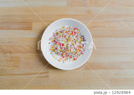 Sugar sprinkles in a bowl on wood 12928964