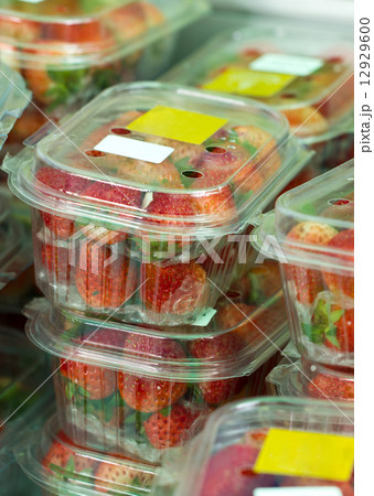 Fresh strawberries in closed plastic boxes in market. 12929600