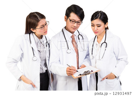Three medical doctors in discussion over a diagnosis Three medical doctors in discussion over a diagnosis 12931497
