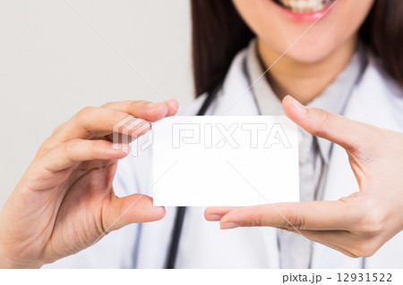 Female doctor holding blank placard Female doctor holding blank placard 12931522