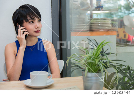 Woman speaking on the phone Woman speaking on the phone 12932444