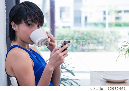 Woman glancing over while sipping Woman glancing over while sipping 12932461