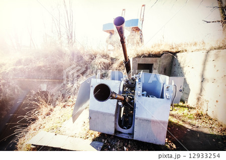 Retro filtered photo of a antiaircraft gun muzzle. 12933254