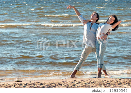 young couple dancing on a background of sea 12939543